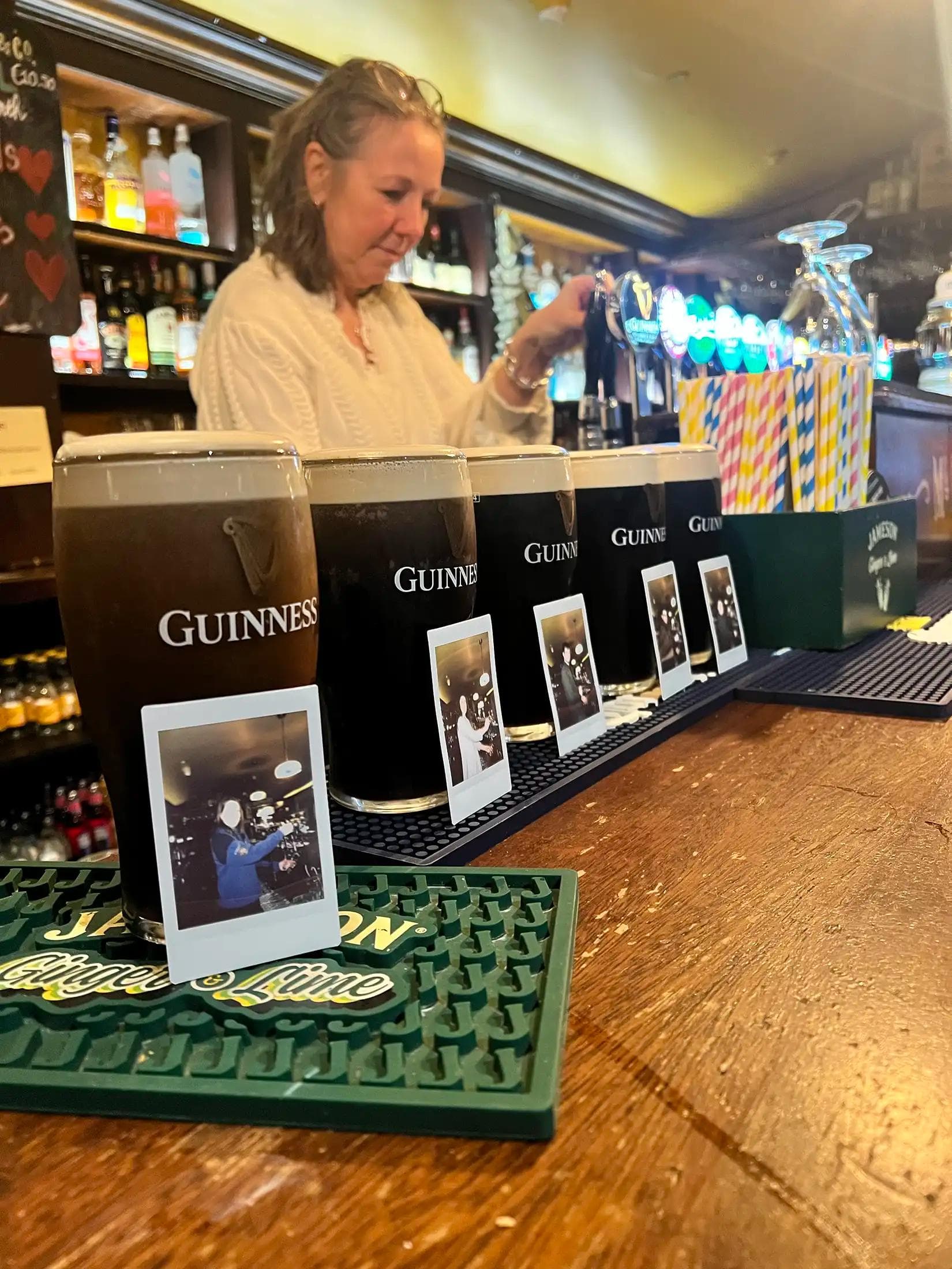 The Stroll to the Stout crew raising pints behind a Galway bar