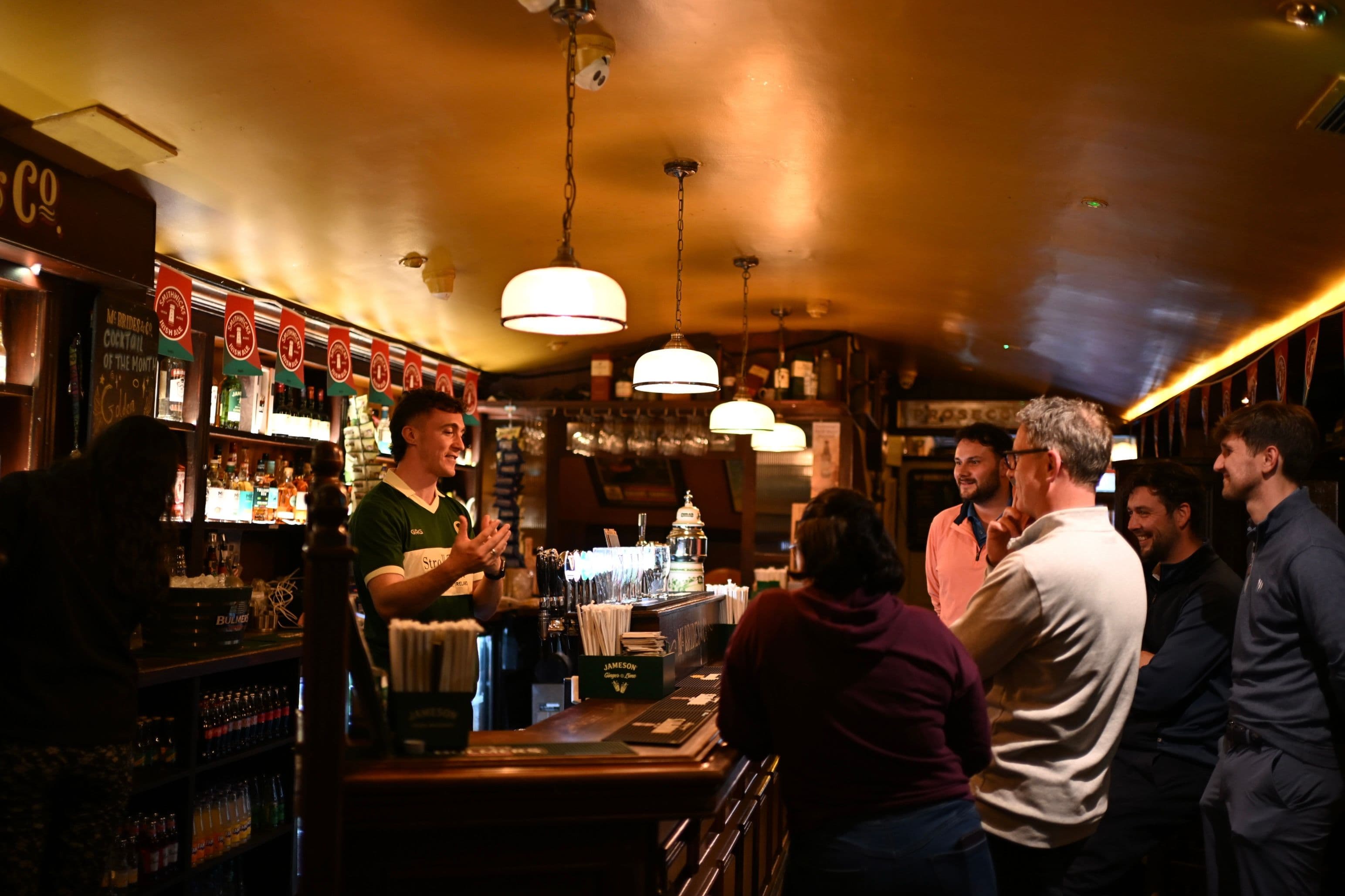 The Stroll to the Stout crew raising pints behind a Galway bar